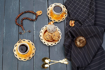 Nut balls dessert served with coffee on dark wooden table, top view
