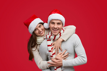 Cheerful woman hugging boyfriend during Christmas party