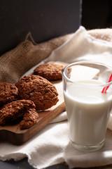 Chocolate crispy cookies with glass of milk close up