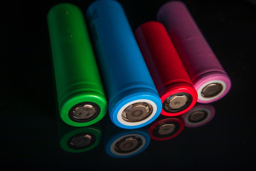 Industrial lithium ion (li-ion) batteries different types and size with reflection on shiny black...