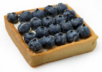 Sand cake with fruit filling, on a white background