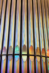 Close up of pipe organ pipes with Rainbow reflection.