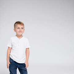 cute little boy thinking about something - copy space over white background