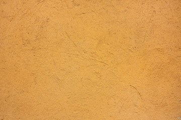 Yellow painted plastered wall. Rough textured background 