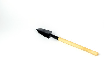 Little shovel, wooden handle, decorative tools. Isolated on white background. Close up shot.