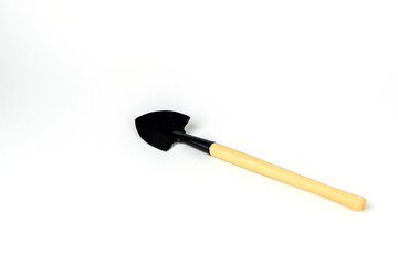Little shovel, wooden handle, decorative tools. Isolated on white background. Close up shot.