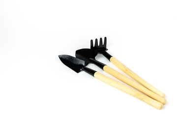 Mini rake and spade for pots gardening. isolated on white background. Close up shot. with copy space.