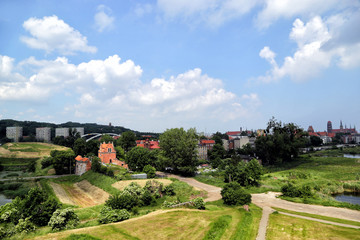 Gdansk, Poland - 06/08/2019: View of the old city gates of Brama Nizinna from a hill in the area of fortifications.