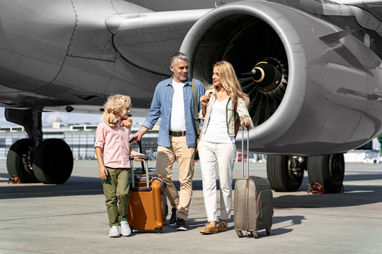 Happy Family Going On Boarding A Plane