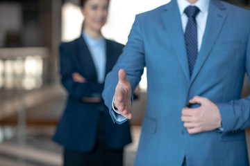 Businessman passing his hand while greeting customers in the office