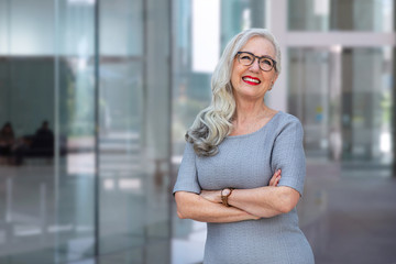 Stylish energetic and enthusiastic business woman CEO smiling with personality at office workplace
