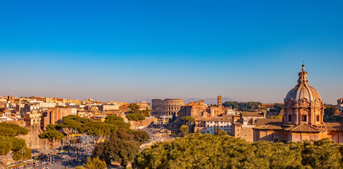 Fototapeta na wymiar Panorama Rome Italy, sunset city Colosseum ruins Roman Forum from square of Venice