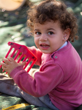 A Little Greek Girl Has Fun While Picking Her Family Olives In An Olive Garden On An Island In 