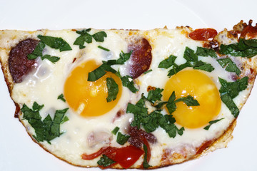 Scrambled eggs consist of two eggs. Scrambled eggs with green onions and red pepper. Top view. Close-up. A place for an inscription. Use for menus and illustrations.