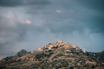 Storm clouds over village of Sant'Antonino in Corsica