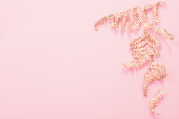 painted golden leaves fern on pink paper background