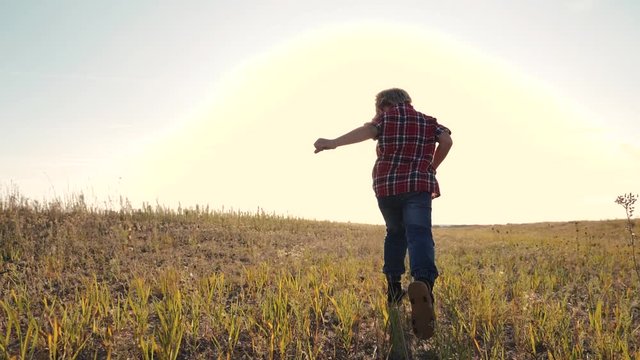 happy family little boy a runs concept slow motion video. happy child girl with sunset nature outdoors running lifestyle on meadow in summer in nature . happy carefree childhood concept