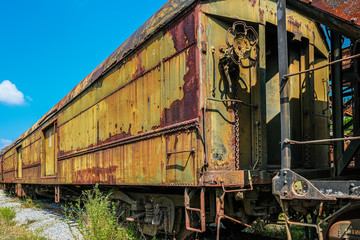 Fototapeta na wymiar Rust on Yellow Train in Abandoned Yard