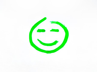 Smiley face with a smile painted on paper. Joyful and smiling smiley green painted with gouache and brush.