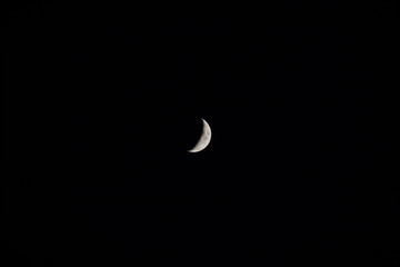 Obraz na płótnie Canvas Crescent moon in the center of the dark sky.