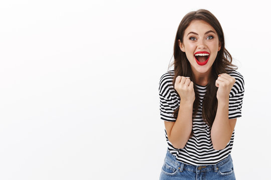 Come on you can do it. Cheerful supportive girlfriend rooting for favorite team, feeling lucky upbeat, wanna win, smiling excited camera, fist pump, clench arms triumphing, celebrating victory