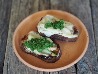 brown bread sandwiches with sun-dried tomatoes on a rustic wooden tableOLYMPUS DIGITAL CAMERA