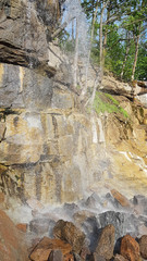 Fototapeta na wymiar Waterfall in the rock of the dendrological park Sofiyivka