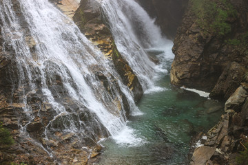Fototapeta premium The view of waterfall in Bad Gastein, Austrian Alps, Austria, selective focus