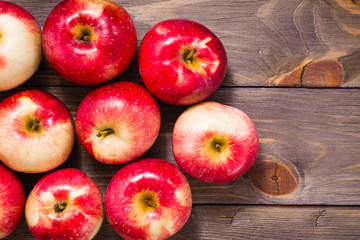 Fresh ripe red apples on a wooden background. Top view