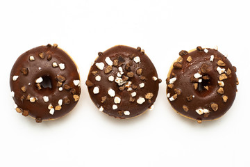 Sweet chocolate donuts with nuts on white background isolated