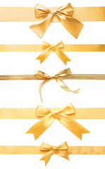 Golden ribbons with beautiful bows on white background