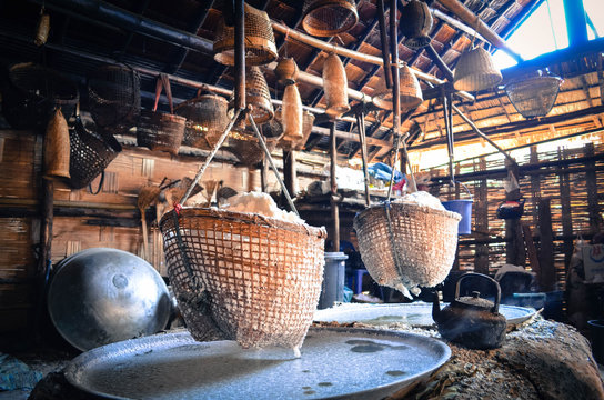 White Sin Thao Salt in basket over heating water from pond at Bo Kluea district, Nan Province, Thailand. The place where produce salt using the traditional method.