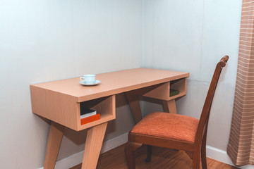 Fototapeta na wymiar Coffee cup on desk in room corner.