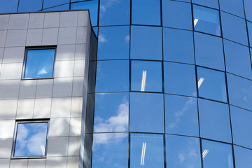 part of reflecting glass facade on modern office building