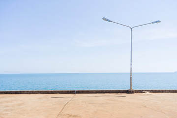 A small pier on the sea. A small bridge over the sea. Autumn season. Street lanterns
