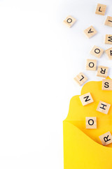 Text, message, letters scattered  in yellow envelope isolated on white background