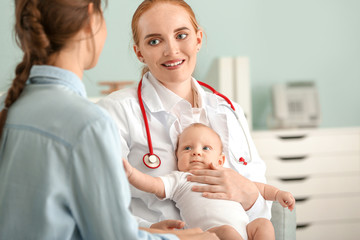 Woman with little baby visiting pediatrician in clinic