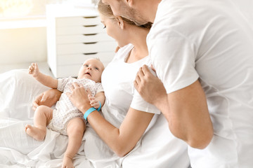 Young family with newborn baby in maternity hospital