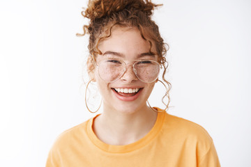 Headshot charming enthusisatic funny 20s carefree young girl having fun laughing happily look...