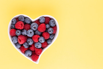 Creative layout made of Blueberry and raspberries on pastel background. Food ingredient pattern.