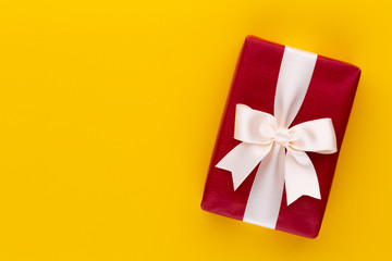 Christmas gift boxes with ribbons on color tabletop.