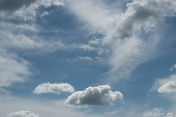 Naklejka na ściany i meble Clouds float through a blue sky