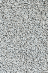 Coarse-grained textured gray background cement finish of the building facade with cement putty