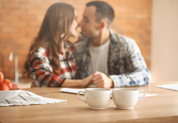 Beautiful young couple having breakfast at home