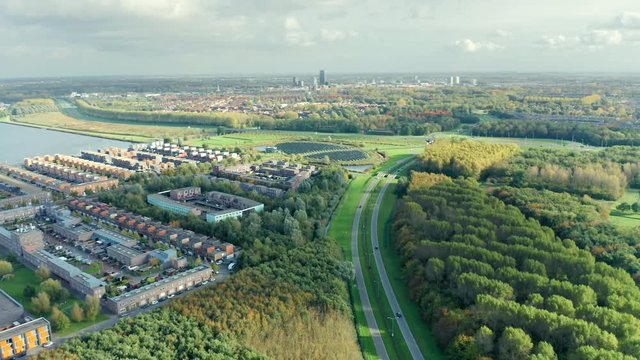 Modern sustainable residential neighbourhood Noorderplassen located close to nature. Aerial view with Almere city visible in the distance.  
