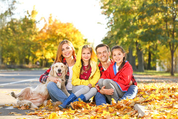 Portrait of happy family in autumn park