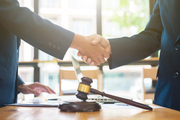 Business people shake hands after legal consultation from a lawyer.
