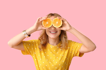 Funny mature woman with cut orange on color background