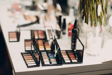 Obraz premium Cosmetics, eye shadow, powder box and other makeup products