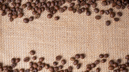 Arrangement of coffee beans on jute with space for copy